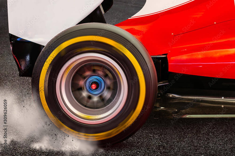 Formula 1 Rear wheel spinning and drifting after launch on a dark asphalt with smoke and dirt flying around