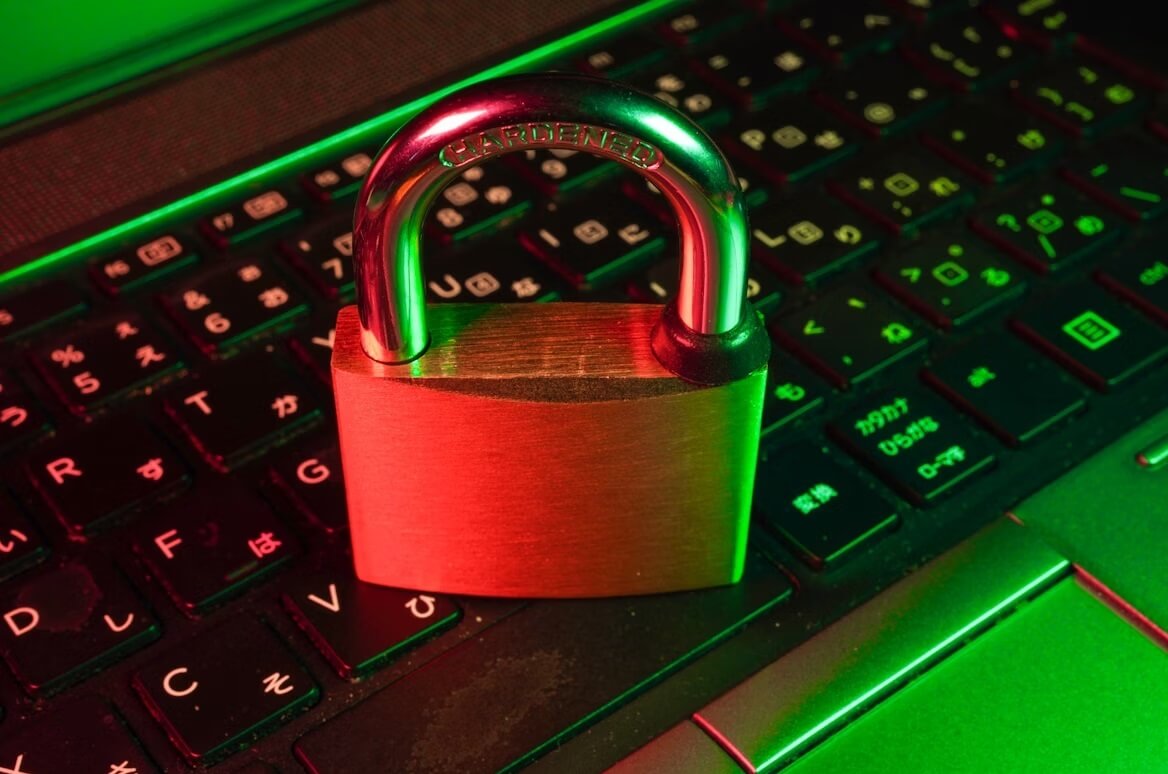 Red padlock on black computer keyboard